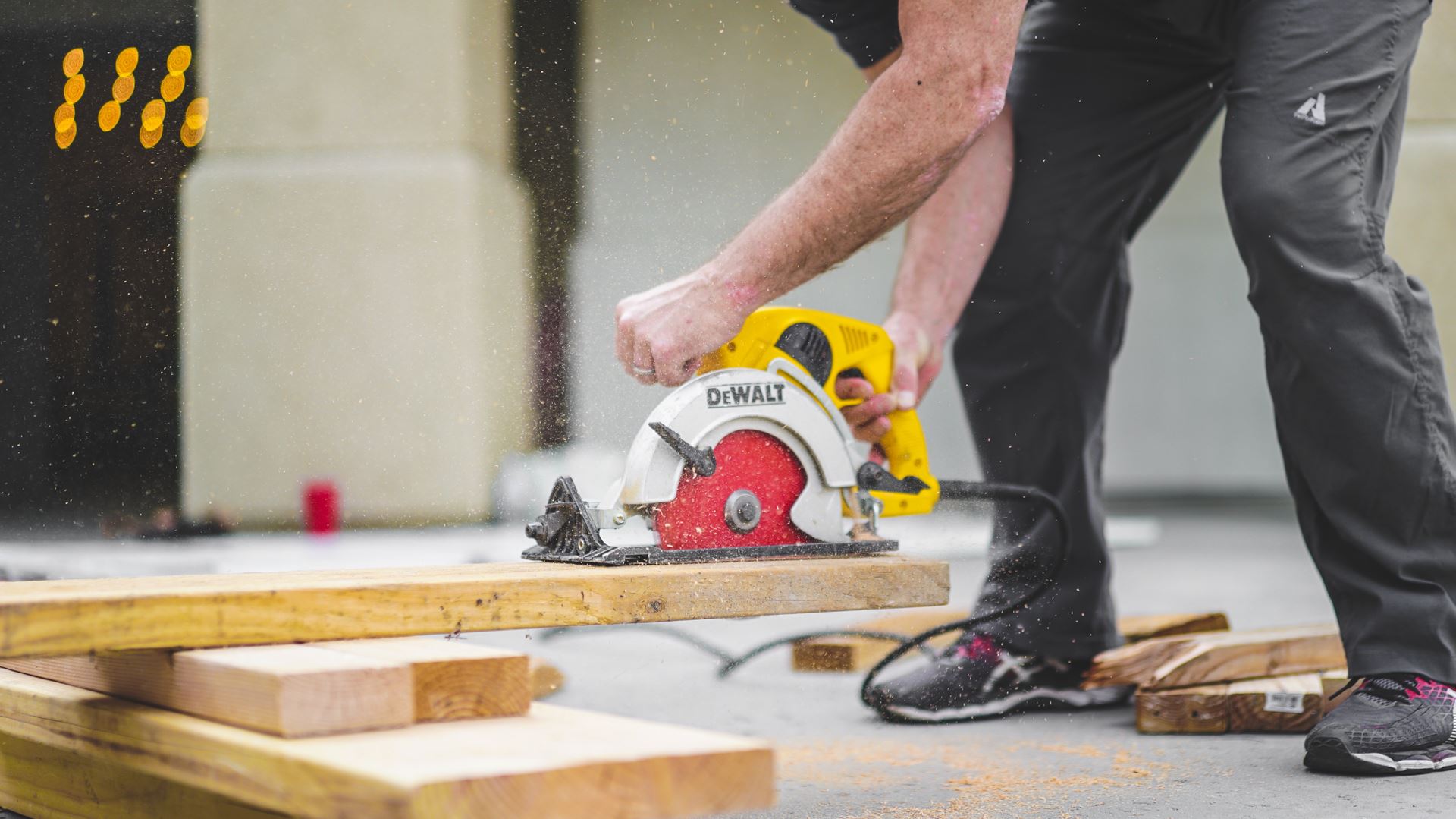 a man standing on top of a cutting board